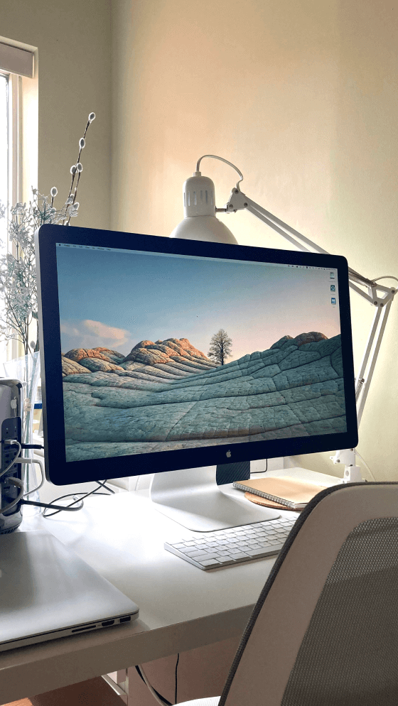 Clean desk space with monitor and lamp